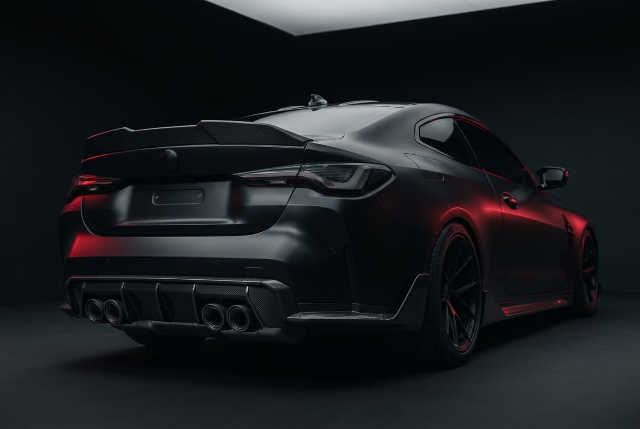 Photoreal render of a 2026 BMW M4 in frozen black with a carbon ducktail and quad carbon exhaust tips.